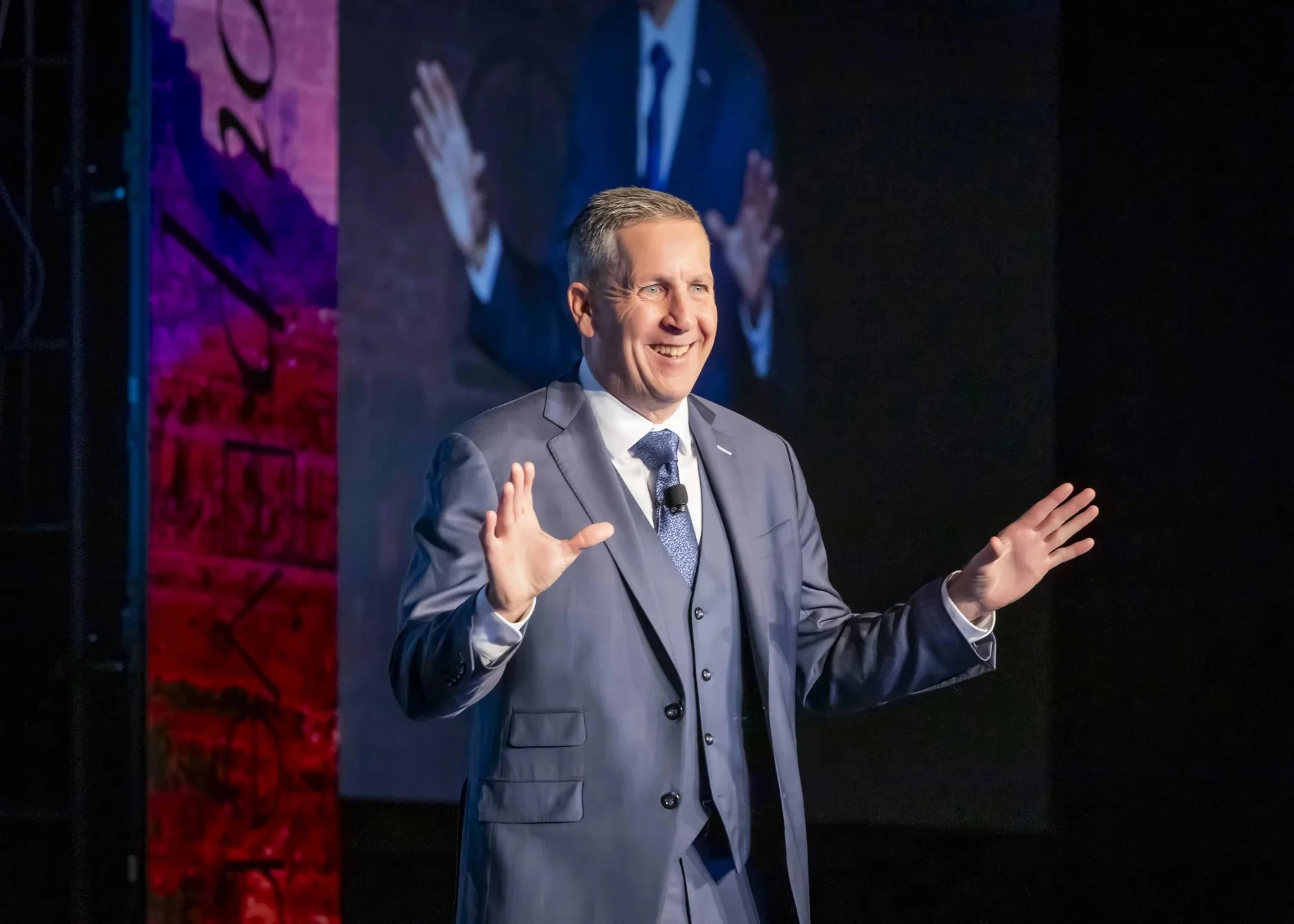 Speaker delivering a presentation on stage