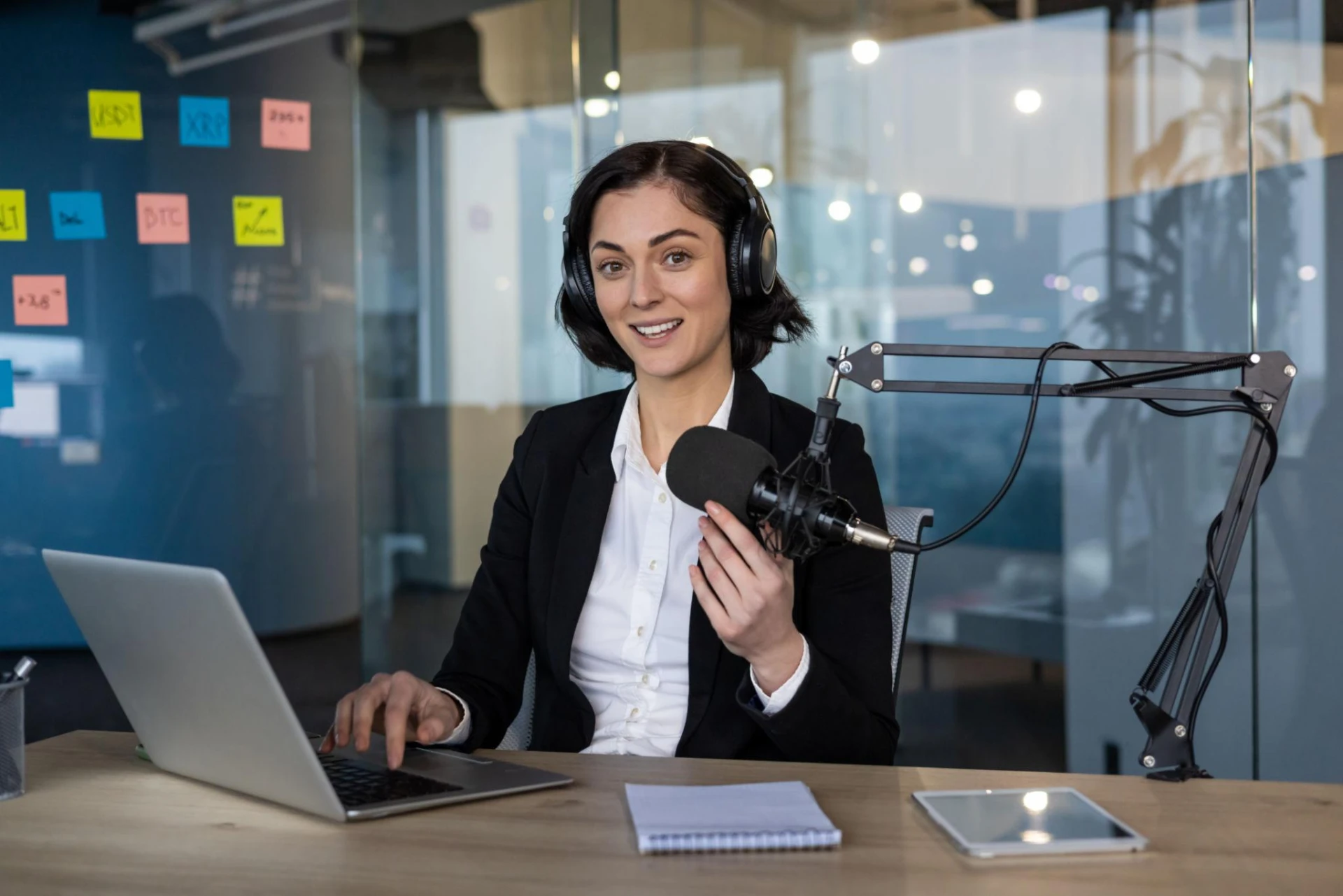 Professional building a digital media platform with a microphone and laptop